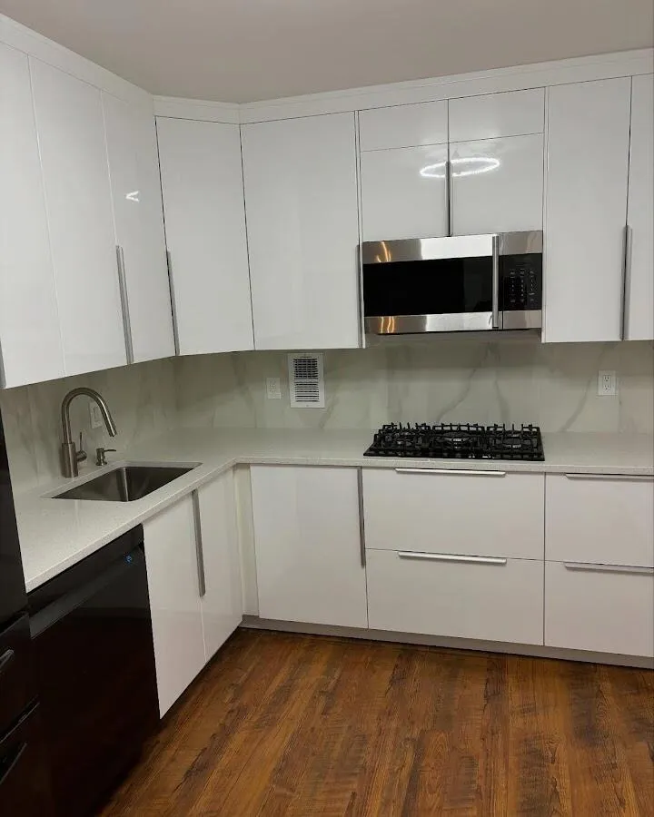 Restored kitchen with white cabinets after water damage in East Rockaway
